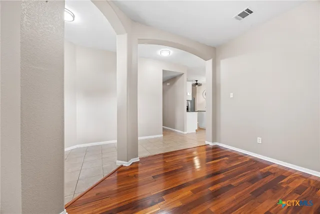 a view of a hallway with wooden floor