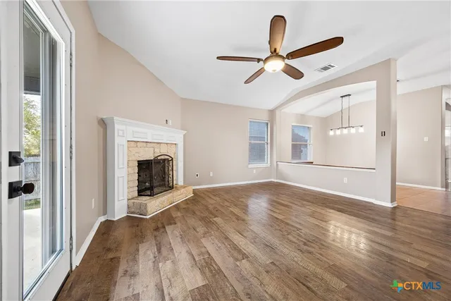 a view of a livingroom with a fireplace and wooden floor
