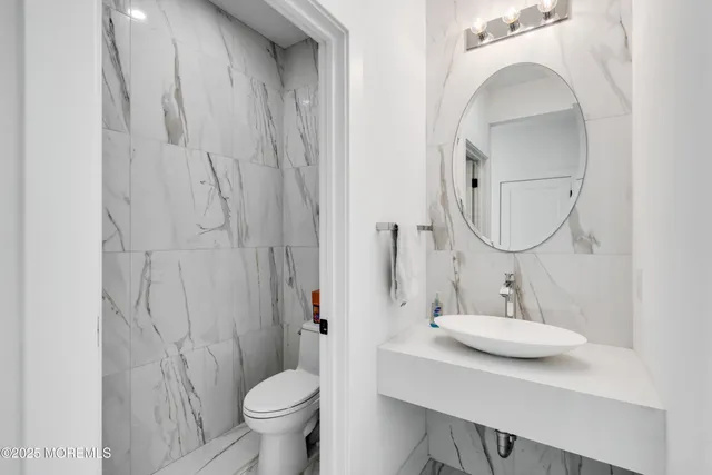 a bathroom with a sink toilet a mirror and vanity