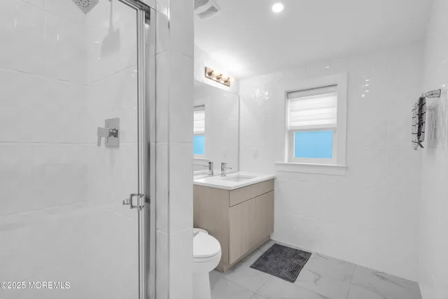 a bathroom with a sink toilet and shower