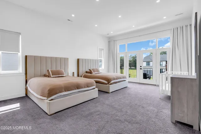 a spacious bedroom with a bed and large window