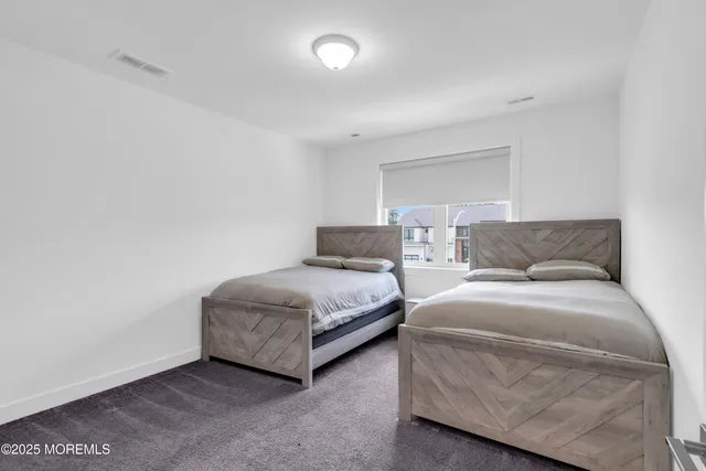 a bedroom with a bed and a night stand