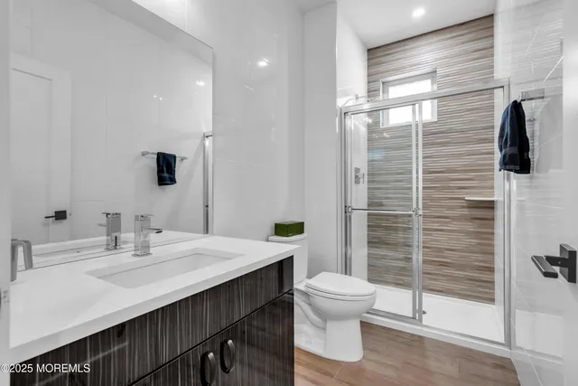 a bathroom with a sink a toilet and shower