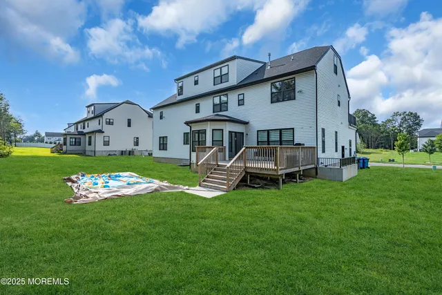a front view of a house with a yard and trees