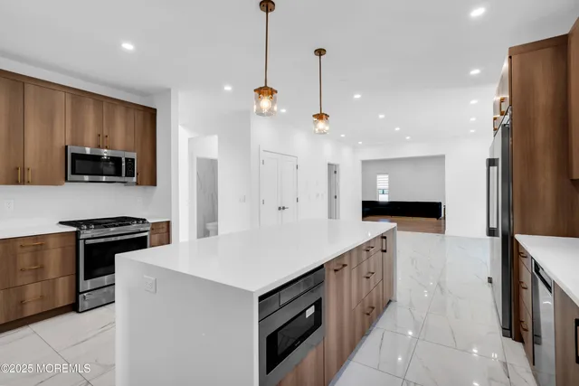 a kitchen with a sink stove and refrigerator