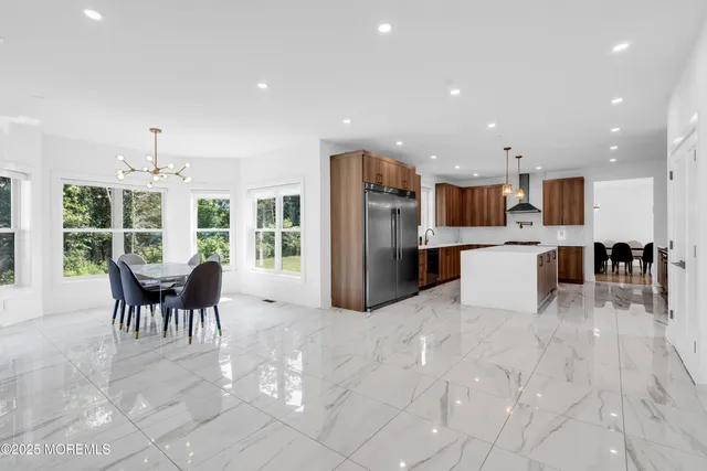 a kitchen with stainless steel appliances kitchen island granite top and refrigerator