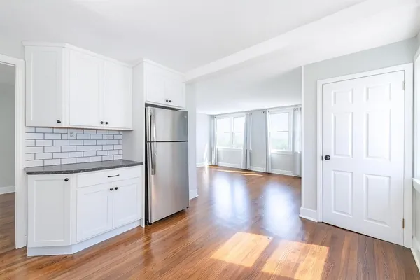 a view of a wooden deck with large trees
