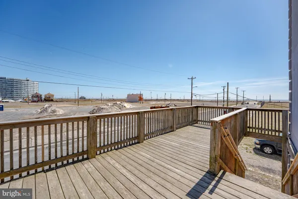 a view of balcony with wooden floor and fence