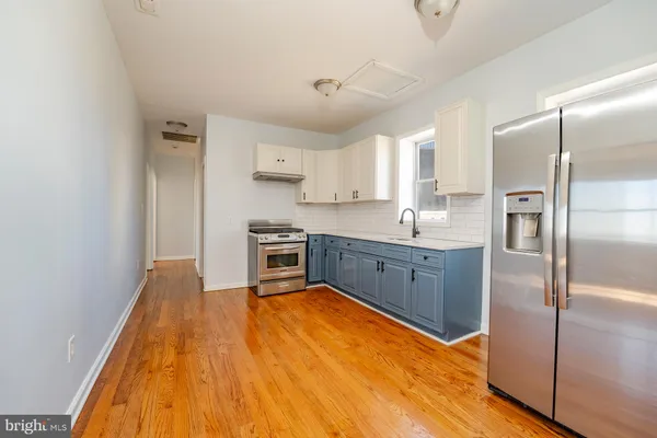 a kitchen with stainless steel appliances granite countertop a sink refrigerator and cabinets