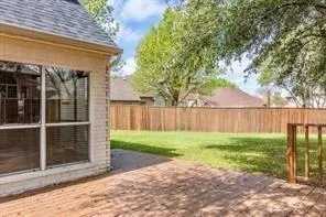 a view of a backyard with wooden fence