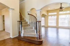 a view of entryway and hall with wooden floor