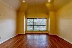a view of room with wooden floor and fan
