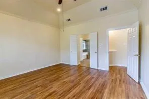 a view of a big room with wooden floor and a bathroom