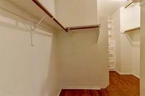 a view of walk in closet with empty racks