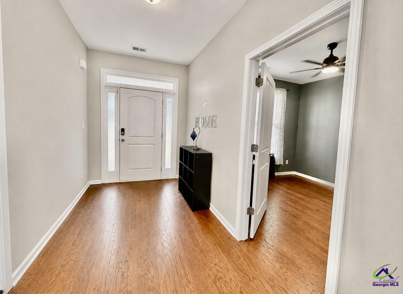 600 Post Oak Way Warner Robins, GA 31088 - Photo 9 of 50 a view of a hallway with wooden floor and staircase