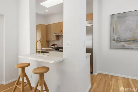 a kitchen with a sink cabinets and a refrigerator