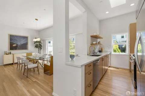 a kitchen with lots of counter top space and painting on the wall