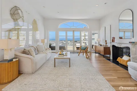 a living room with furniture a fireplace and a view of living room