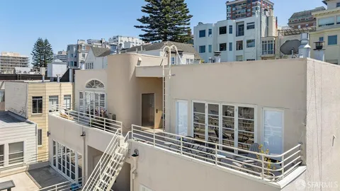 an aerial view of a houses with a city view