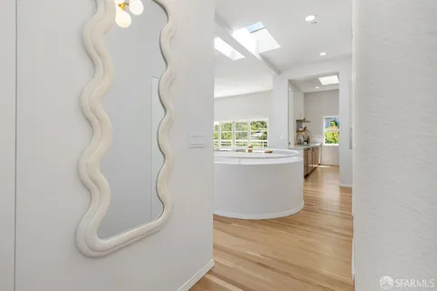 a room with wooden floor and white walls