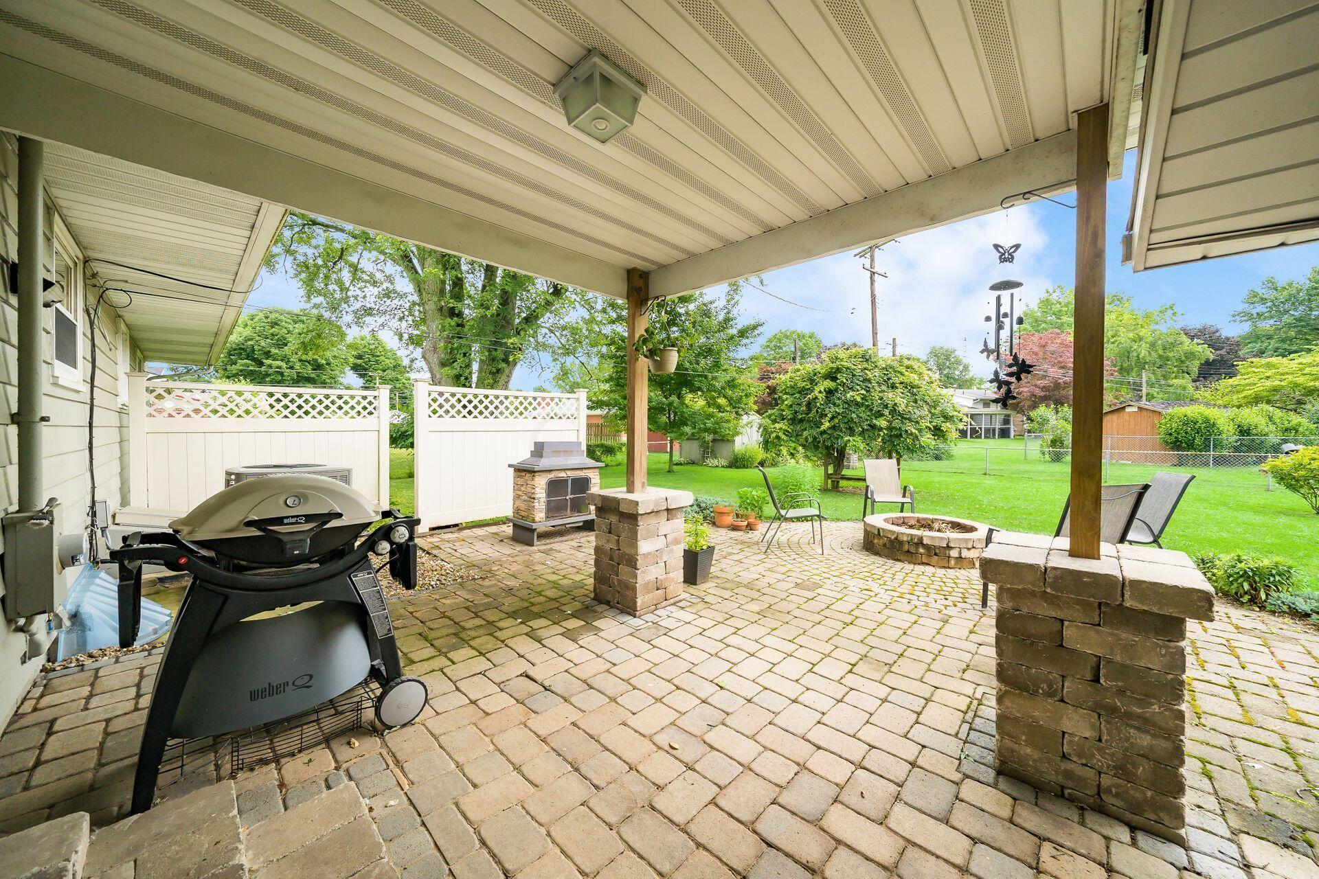 350 Jefferson Road Newark, OH 43055 - Photo 30 of 38 Fenced yard has covered paver patio plus a fire pit!