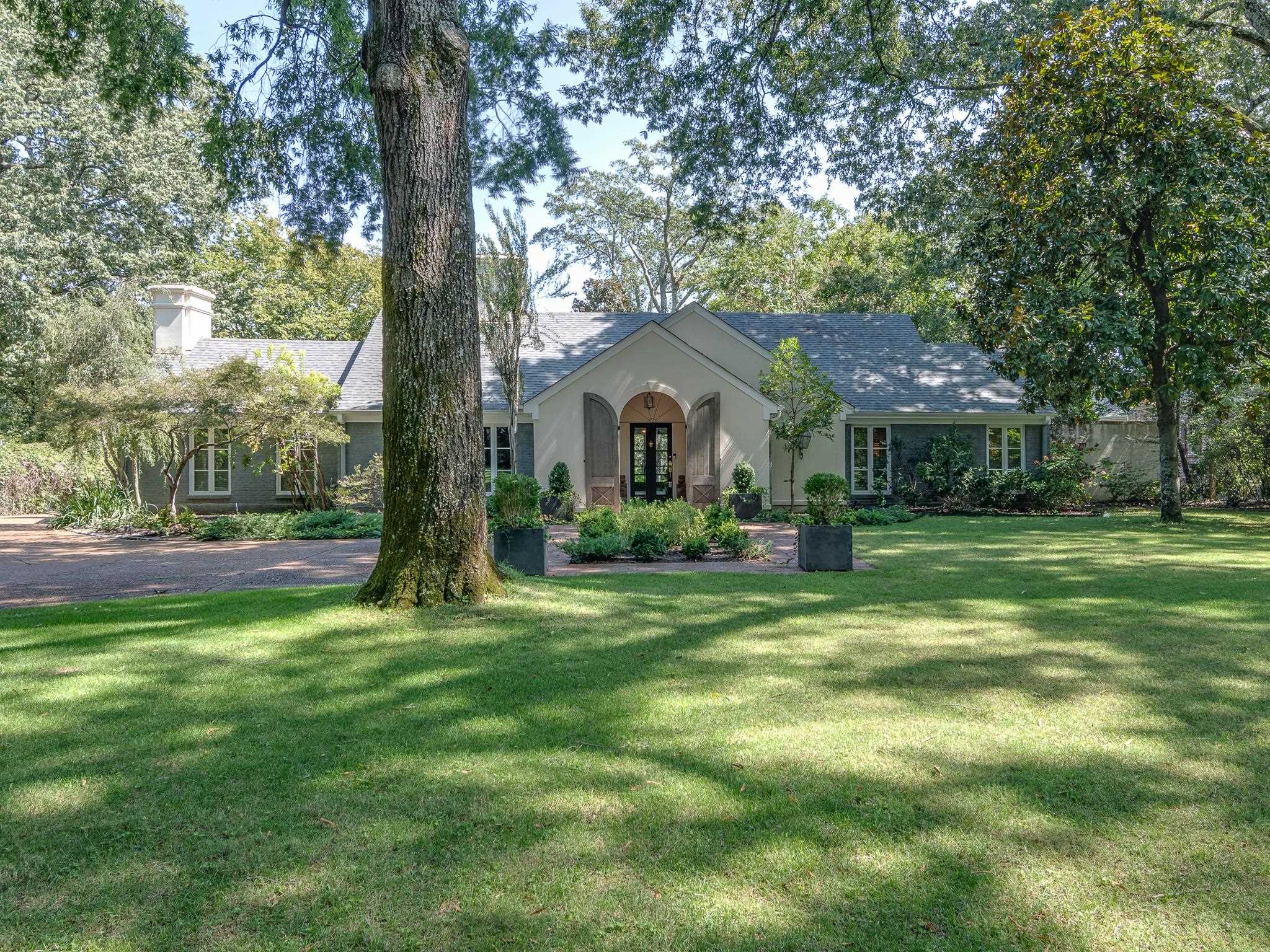 a front view of house with yard and green space
