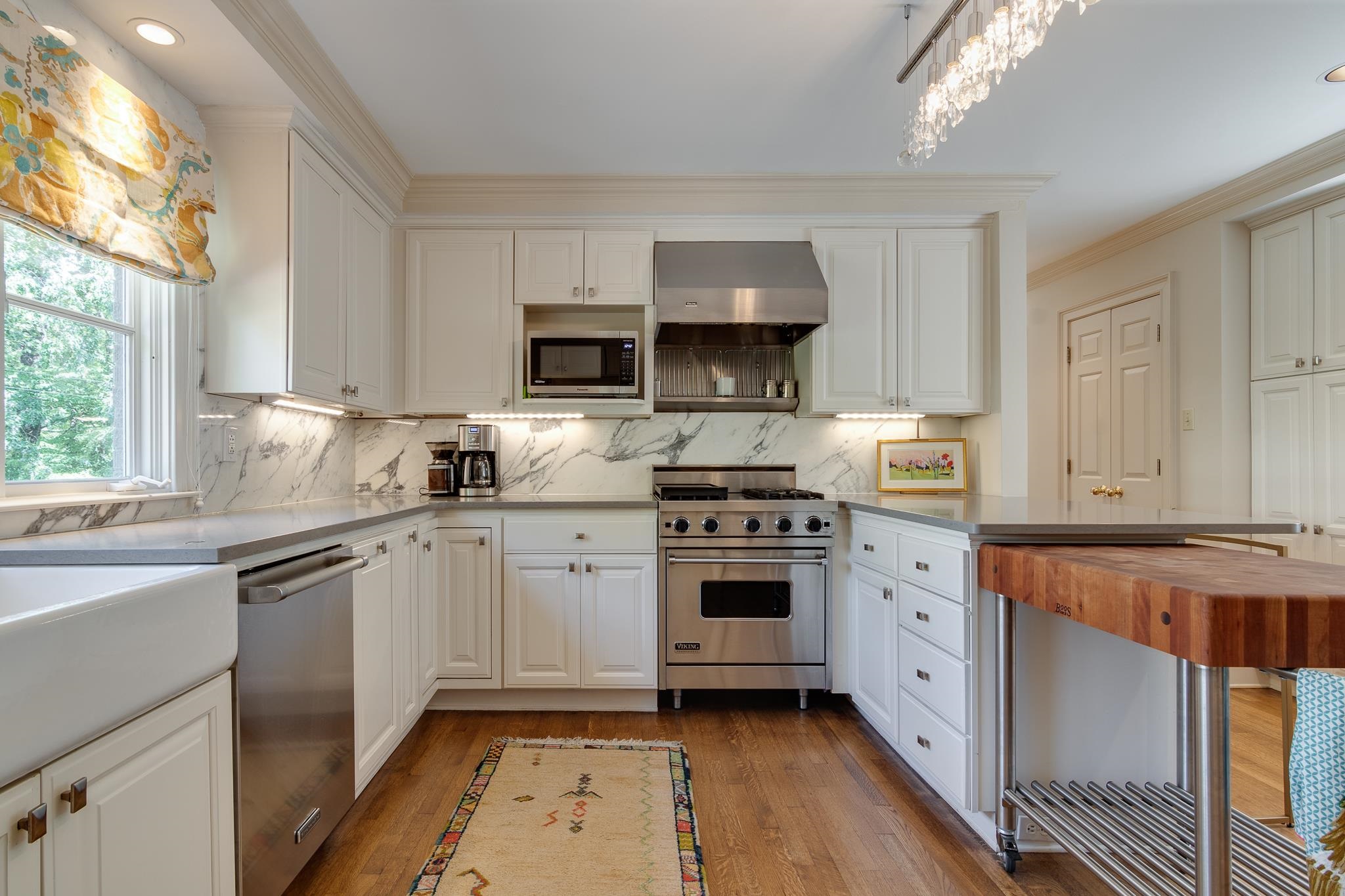 338 Greenway Road Memphis, TN 38117 - Photo 28 of 40 a kitchen with stainless steel appliances a sink stove top oven and cabinets