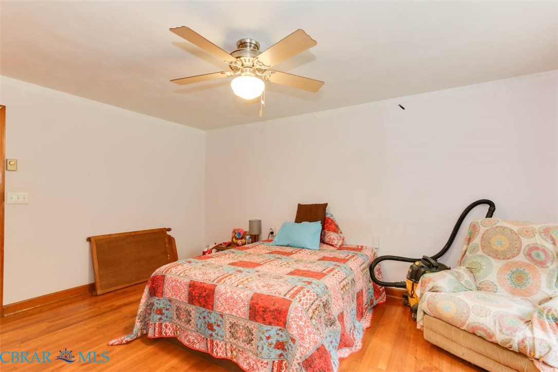 6822 Enfield Road Gloucester, VA 23061 - Photo 24 of 35 Bedroom featuring light wood-type flooring and a ceiling fan