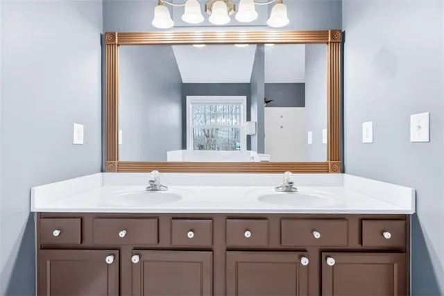 a bathroom with a sink vanity and a mirror