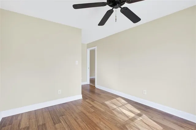 a view of a room with wooden floor