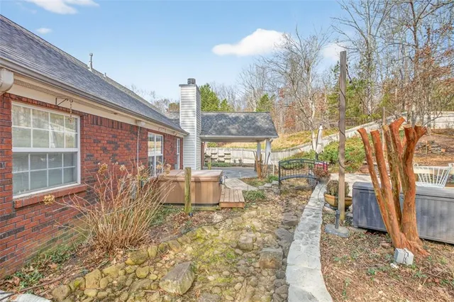 a view of a house with backyard and sitting area
