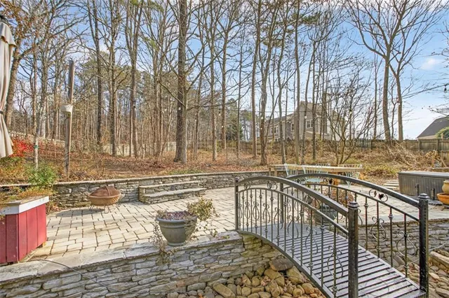 a view of a roof deck with couches and wooden fence