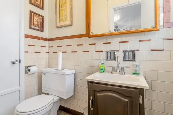 a bathroom with a sink a toilet and shower curtain