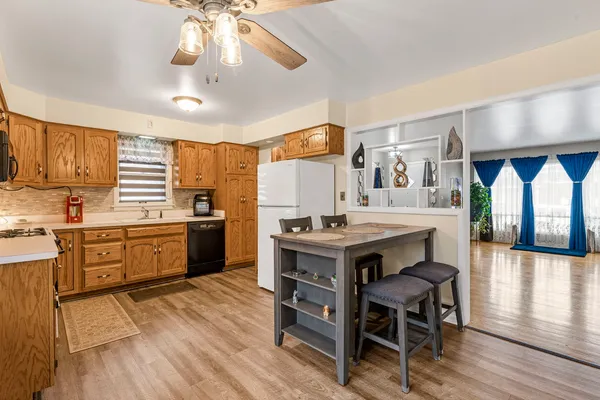 a kitchen with a table chairs stove and cabinets