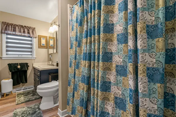 a bathroom with a toilet and a shower