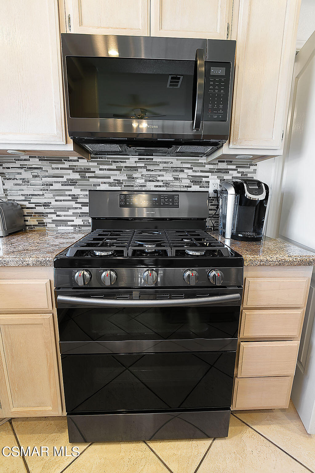 985 Brandon Avenue Simi Valley, CA 93065 - Photo 11 of 40 a stove top oven sitting inside of a kitchen
