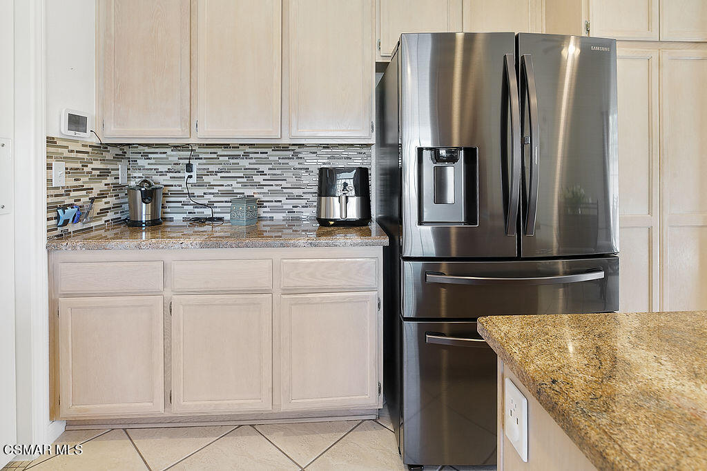 985 Brandon Avenue Simi Valley, CA 93065 - Photo 12 of 40 a kitchen with granite countertop a refrigerator and a sink