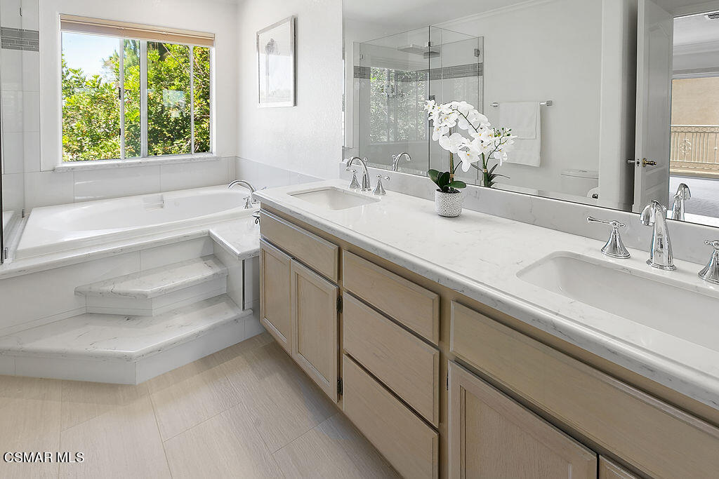 985 Brandon Avenue Simi Valley, CA 93065 - Photo 23 of 40 a bathroom with a double vanity sink and a large mirror