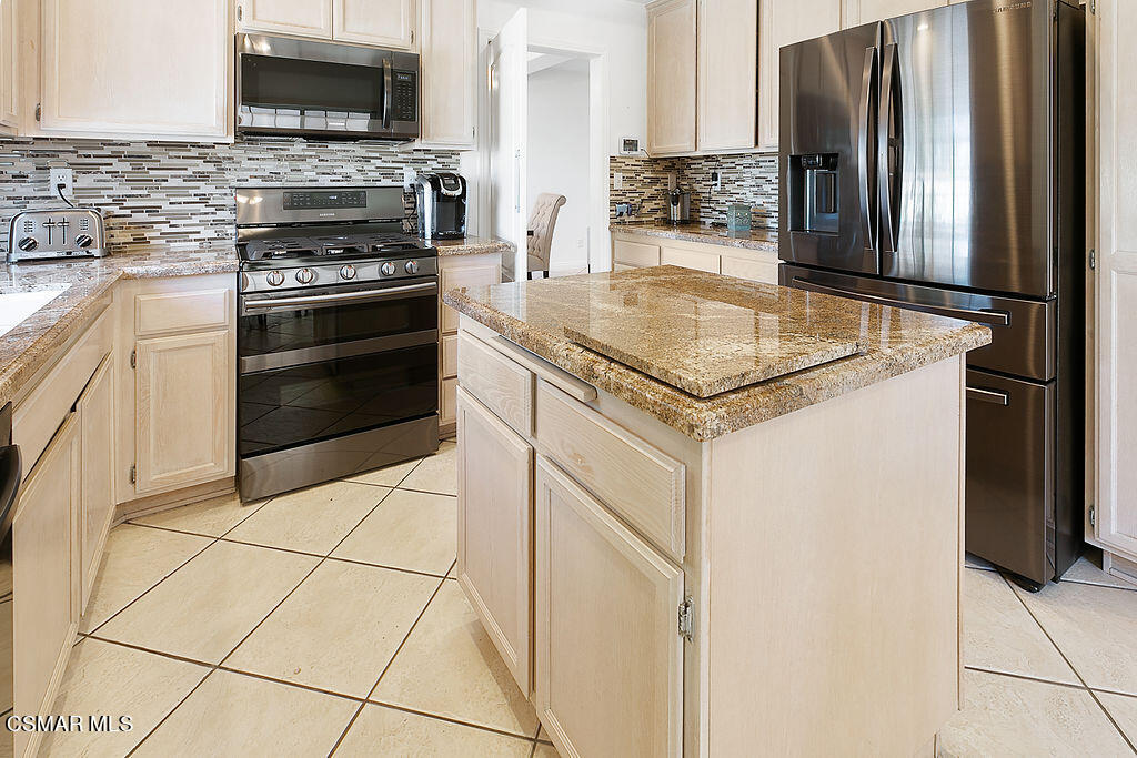 985 Brandon Avenue Simi Valley, CA 93065 - Photo 3 of 40 a kitchen with appliances a sink and cabinets
