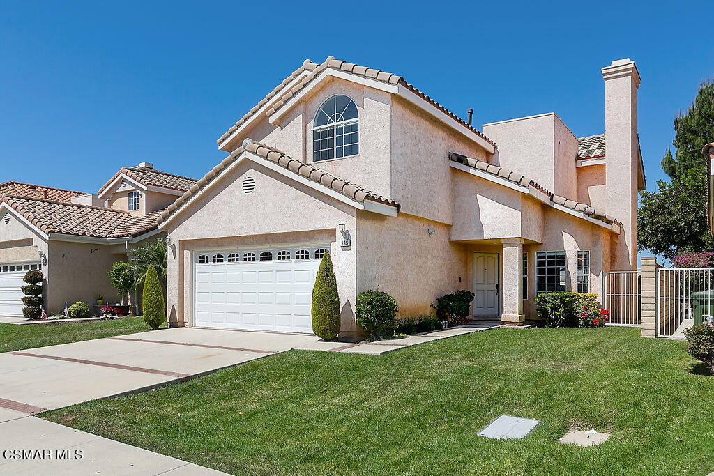 985 Brandon Avenue Simi Valley, CA 93065 - Photo 6 of 40 a front view of a house with a garden and plants