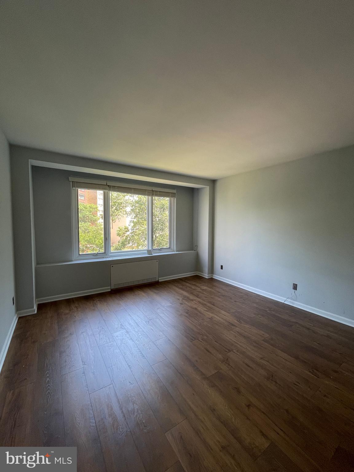 2475 Virginia Avenue Northwest, Unit 411 Washington, DC 20037 - Photo 13 of 20 a view of an empty room with wooden floor and a window