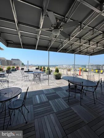 a terrace with outdoor seating and city view