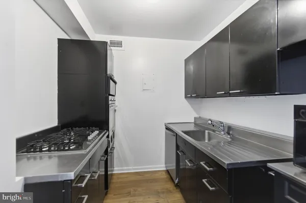 a kitchen with a sink stove and cabinets