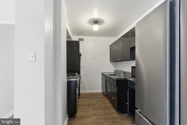 a kitchen with stainless steel appliances granite countertop a refrigerator and a stove top oven