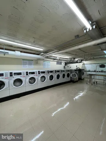 a utility room with stainless steel appliances and stove