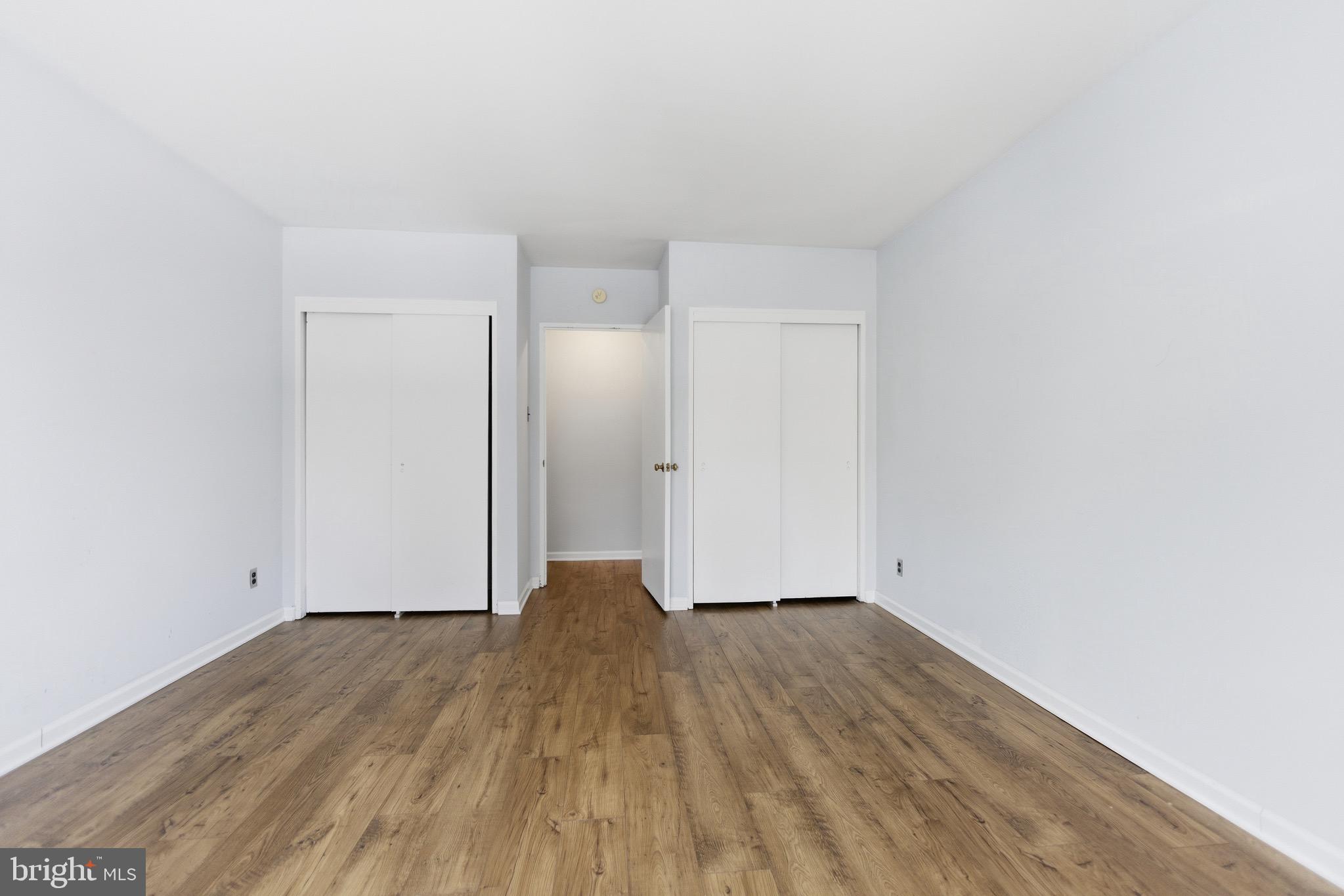 2475 Virginia Avenue Northwest, Unit 411 Washington, DC 20037 - Photo 6 of 17 a view of an empty room with wooden floor