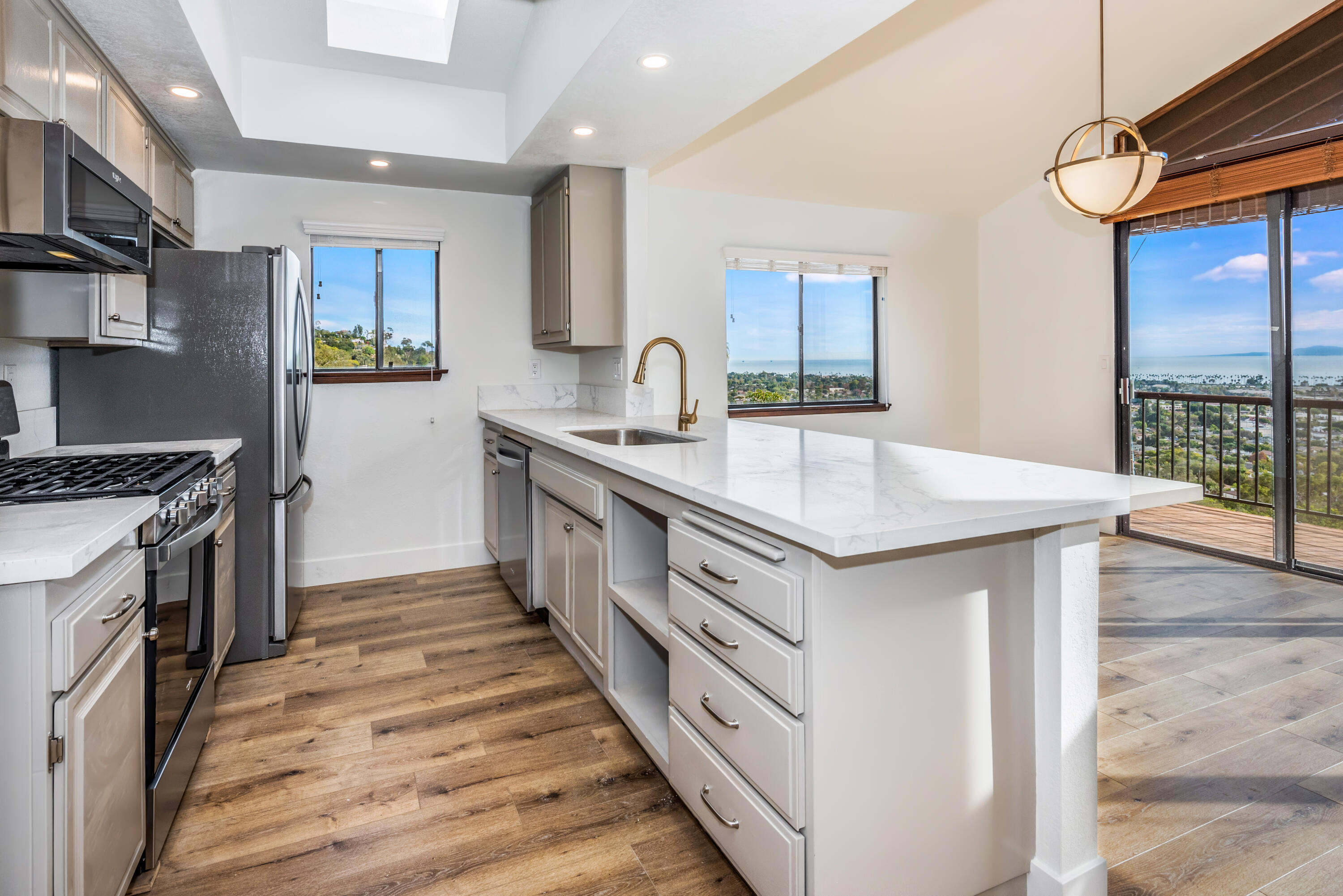 a kitchen with granite countertop a sink and a stove