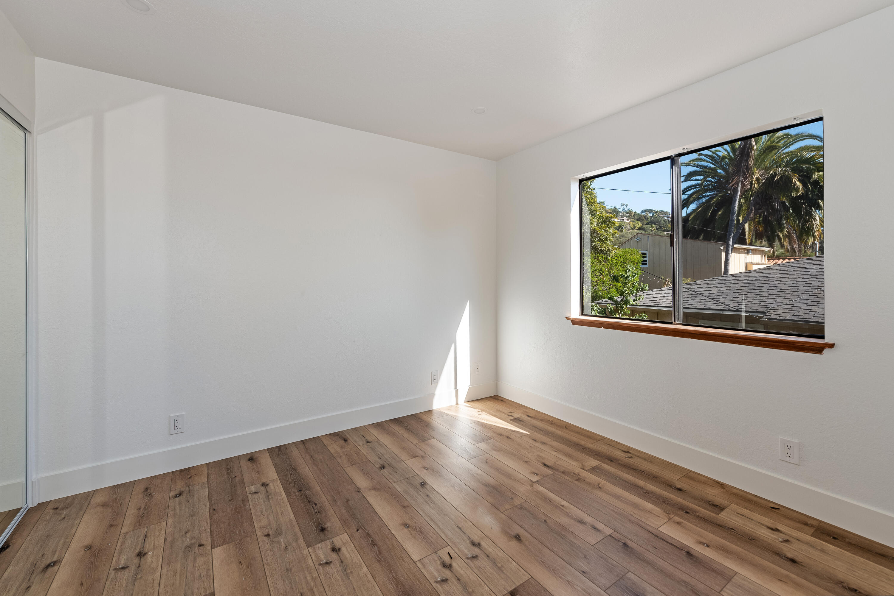 34 Rubio Road Santa Barbara, CA 93103 - Photo 11 of 22 a view of an empty room with wooden floor and a window