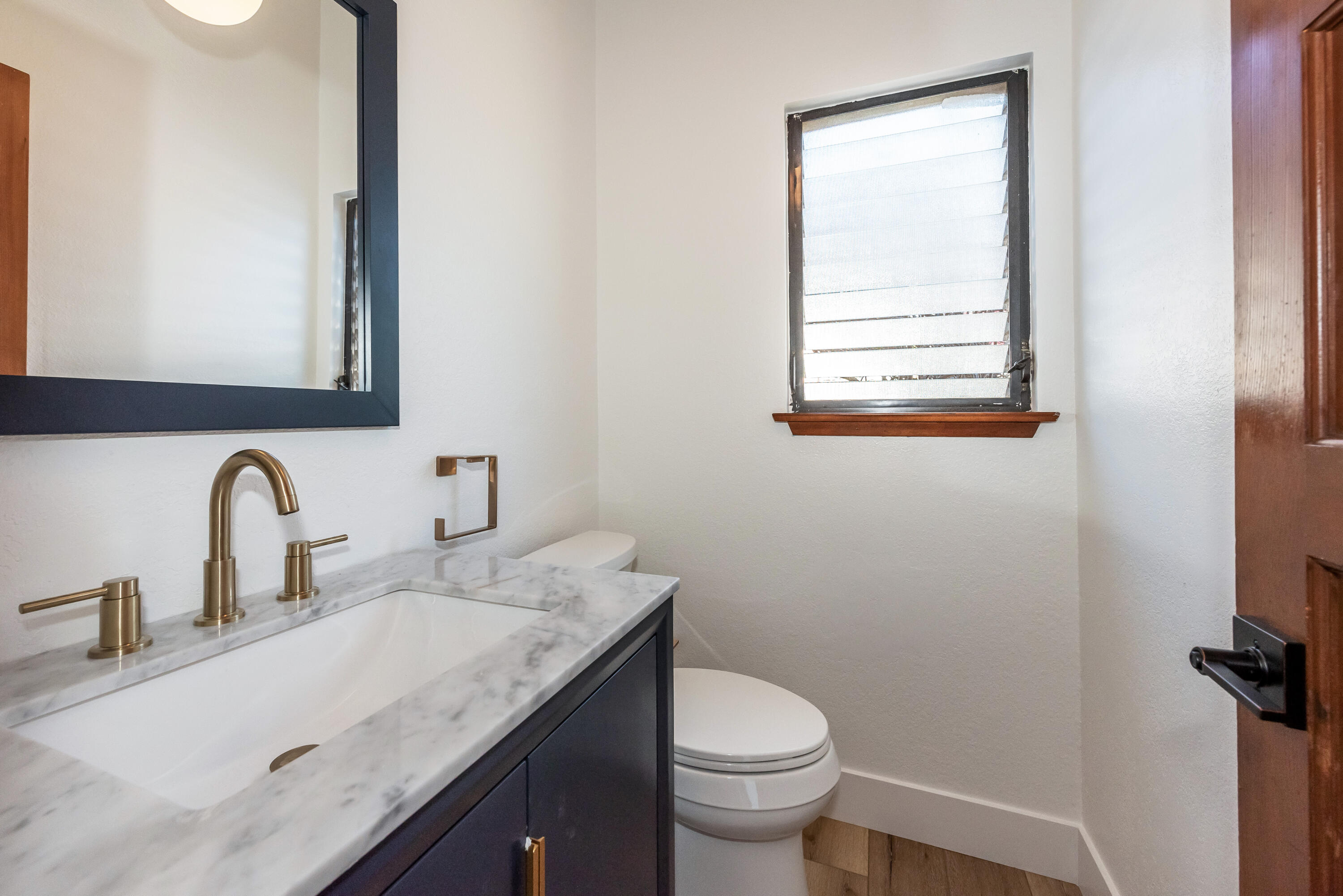 34 Rubio Road Santa Barbara, CA 93103 - Photo 13 of 22 a bathroom with a granite countertop sink a toilet and a mirror