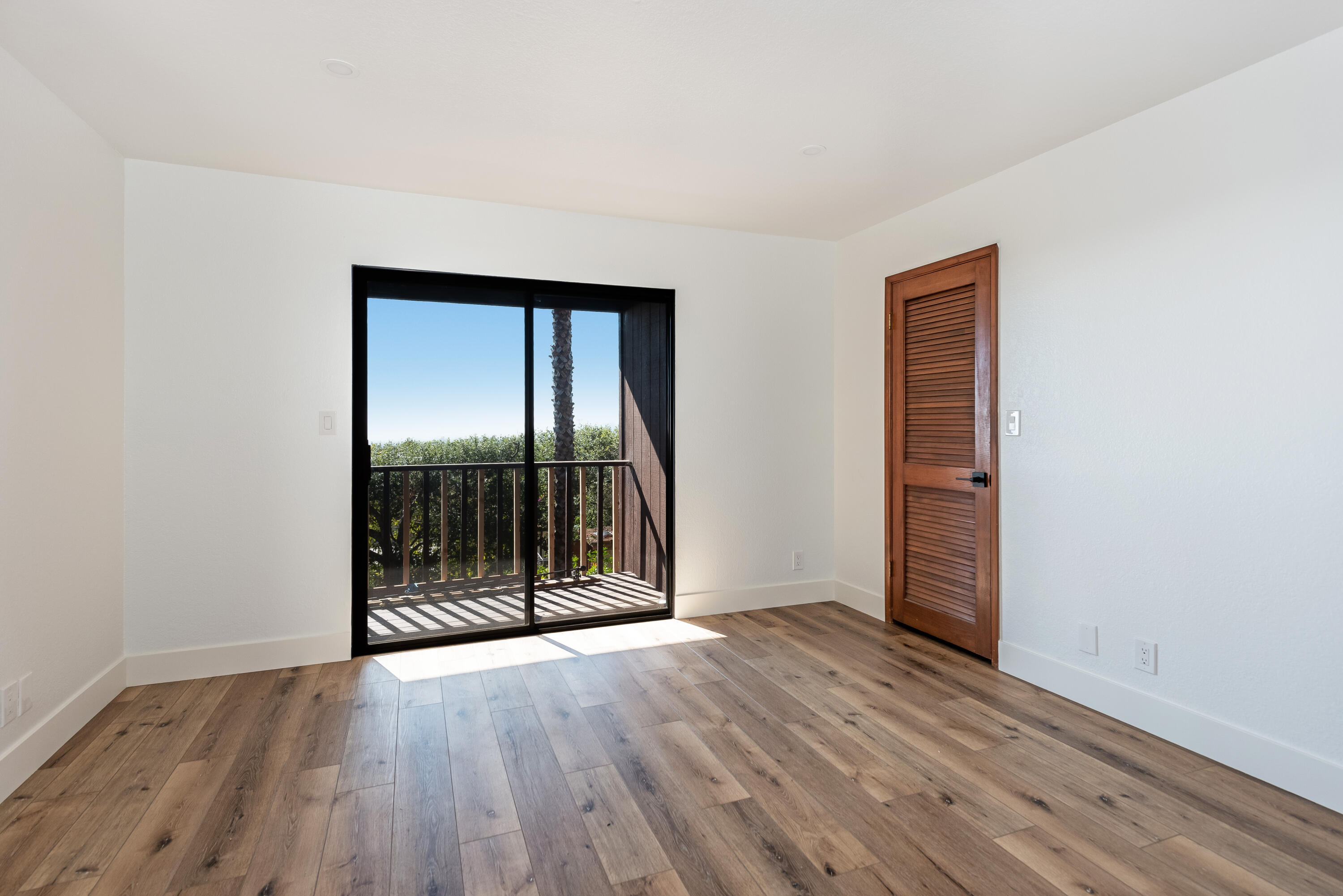 34 Rubio Road Santa Barbara, CA 93103 - Photo 15 of 22 an empty room with wooden floor and windows